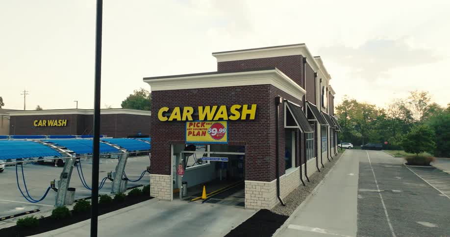 Automatic car wash building with a car wash sign on the facade
