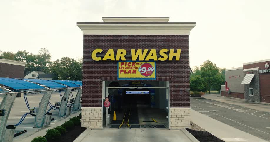 Neighborhood car wash with a sign on the building
