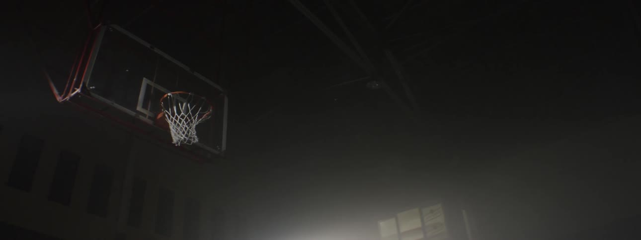A man shooting basketballs through the net on a court
