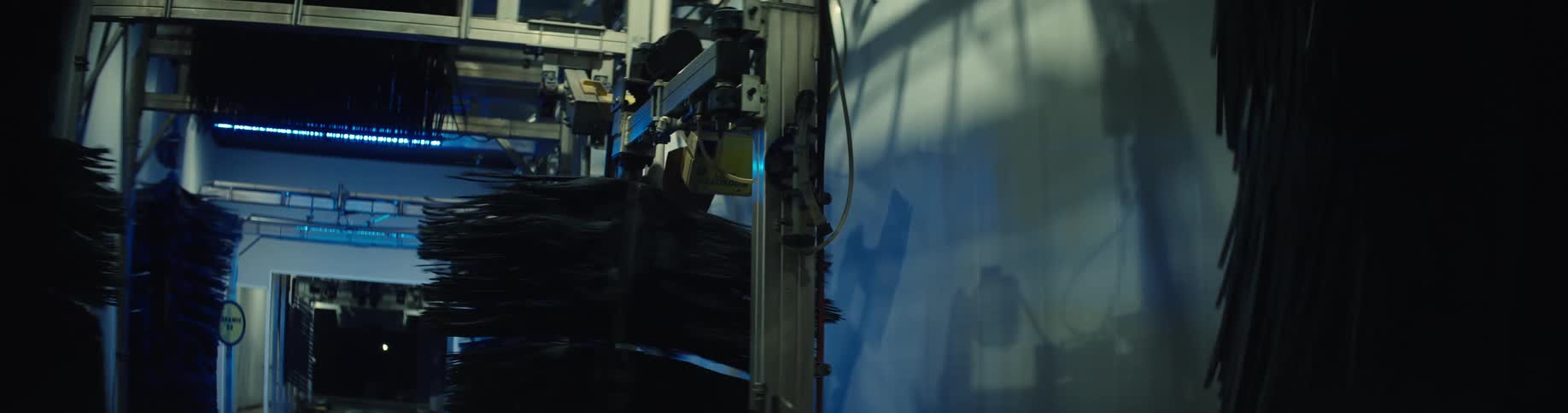 Rotating brushes of an automatic car wash machine in operation