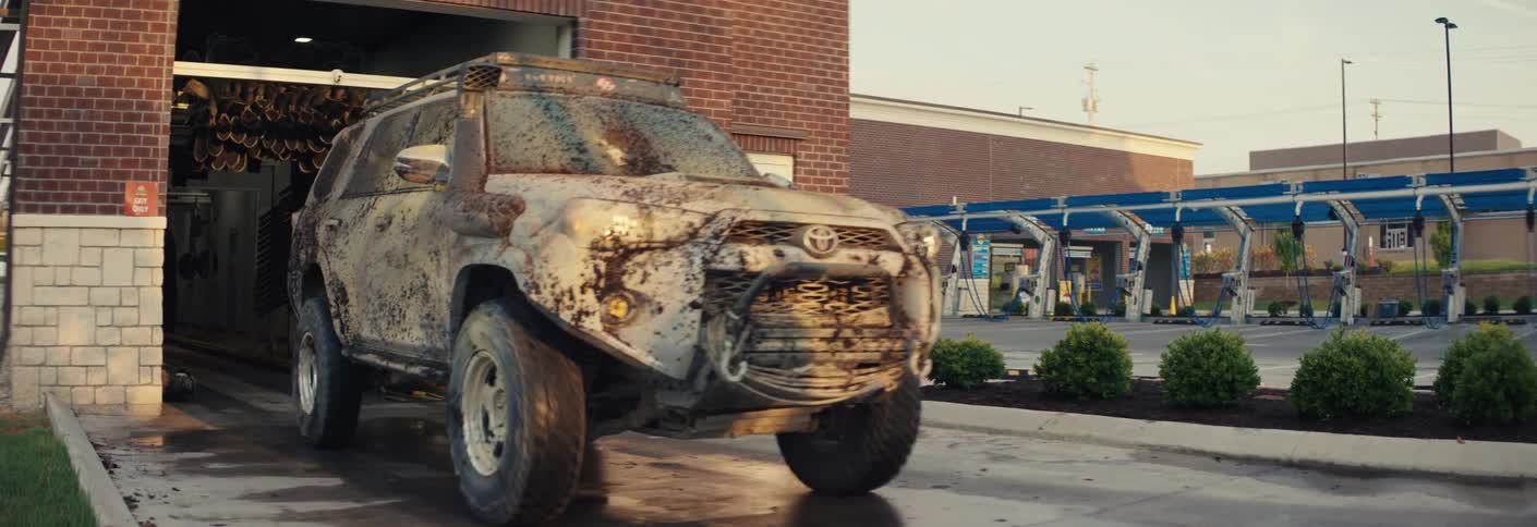 Mudcovered vehicle exiting an automatic car wash