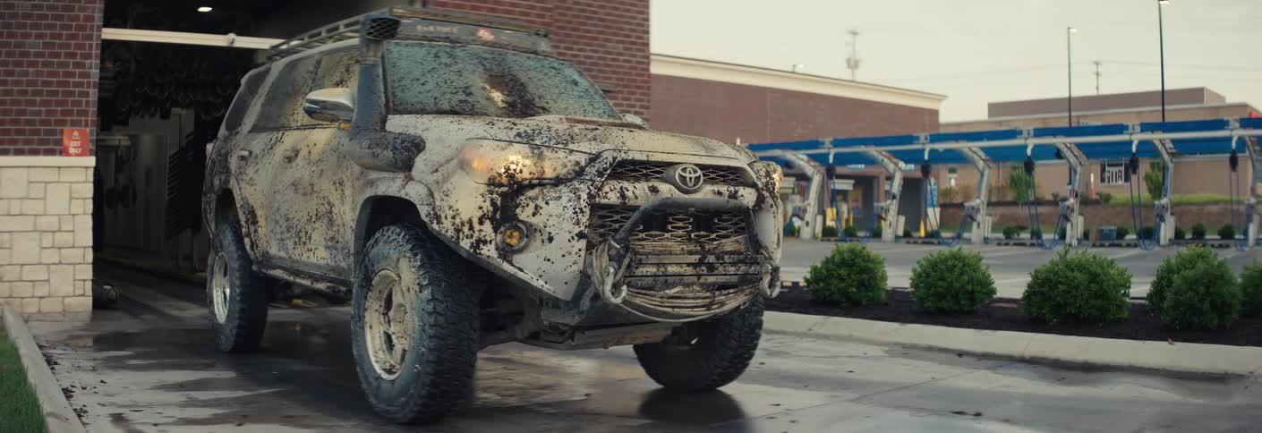 Mudcovered vehicle exiting an automatic car wash