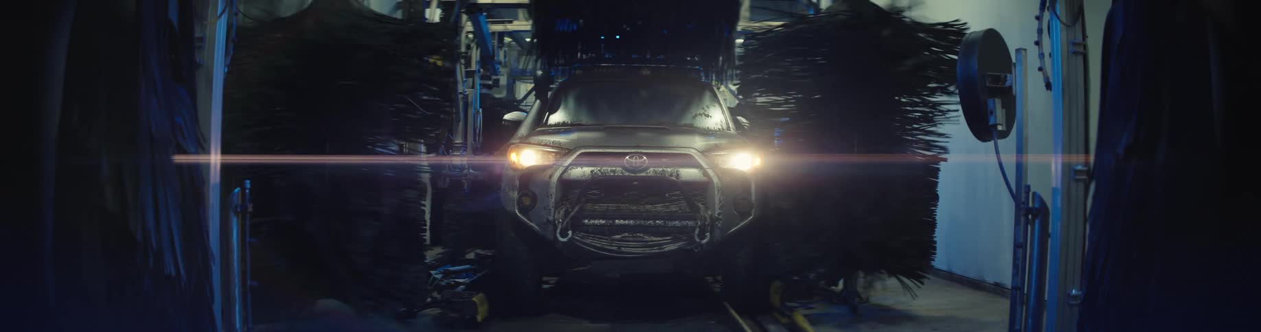 An off road vehicle moves slowly through an automated car wash station