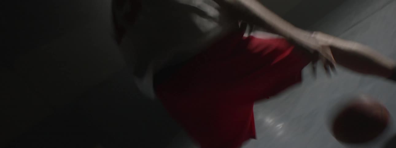 The feet and legs of man dribbling and shooting a basketball