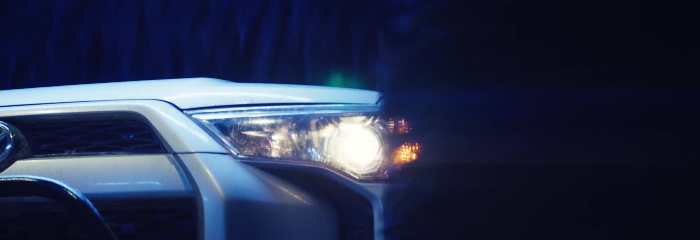 Toyota vehicle moving through an automatic car wash tunnel between rotating brushes