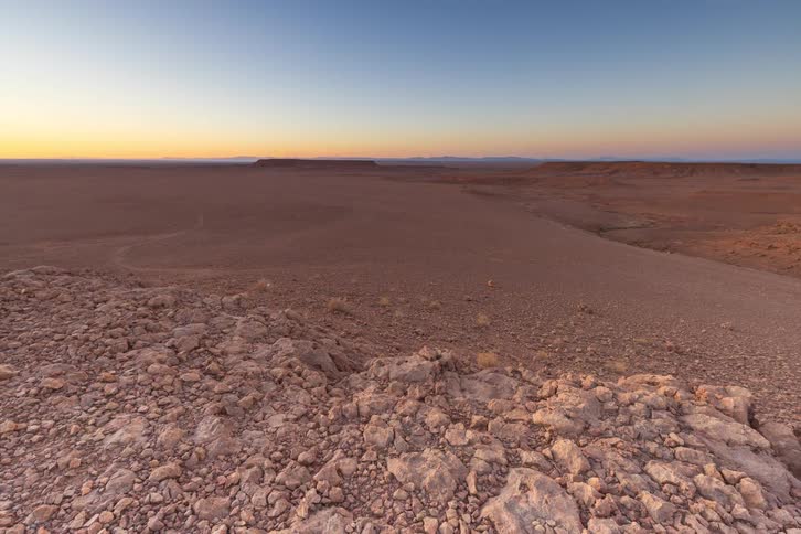 An aerial view of a sunset over a desert