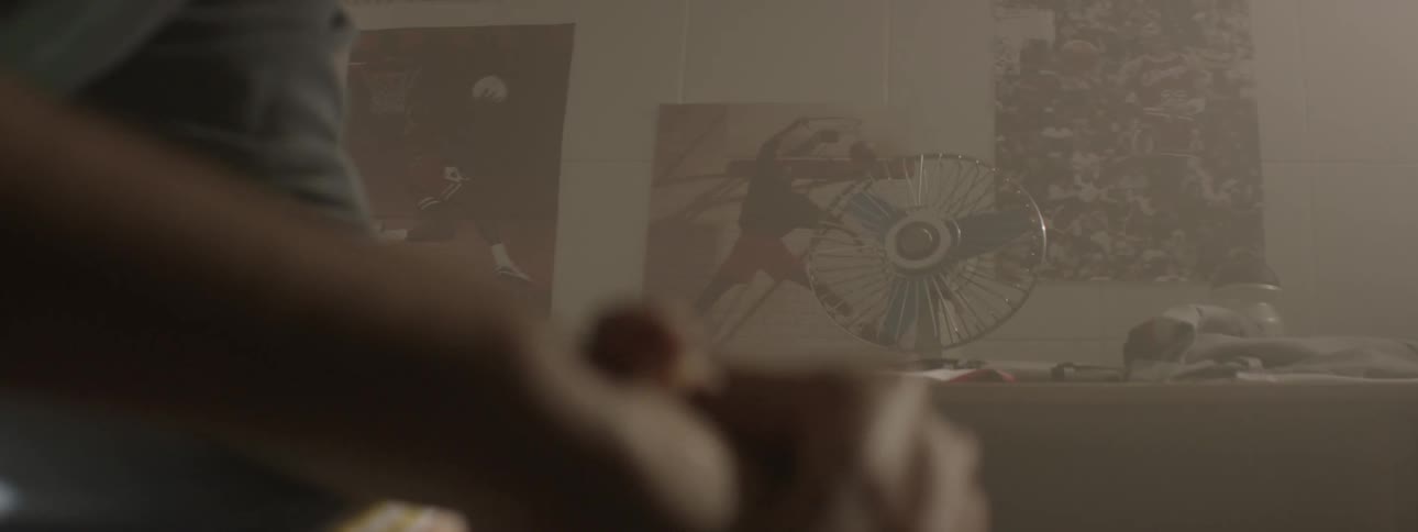 A person clenches fists while sitting in a room
