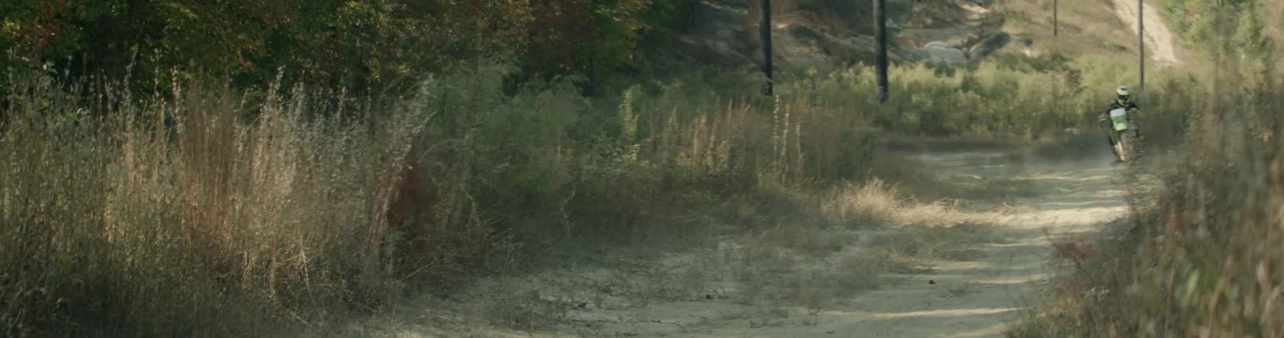 Person riding bike on grassy terrain