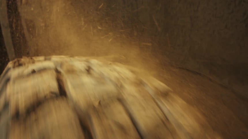Suv tire spins rapidly covered in dirt and mud