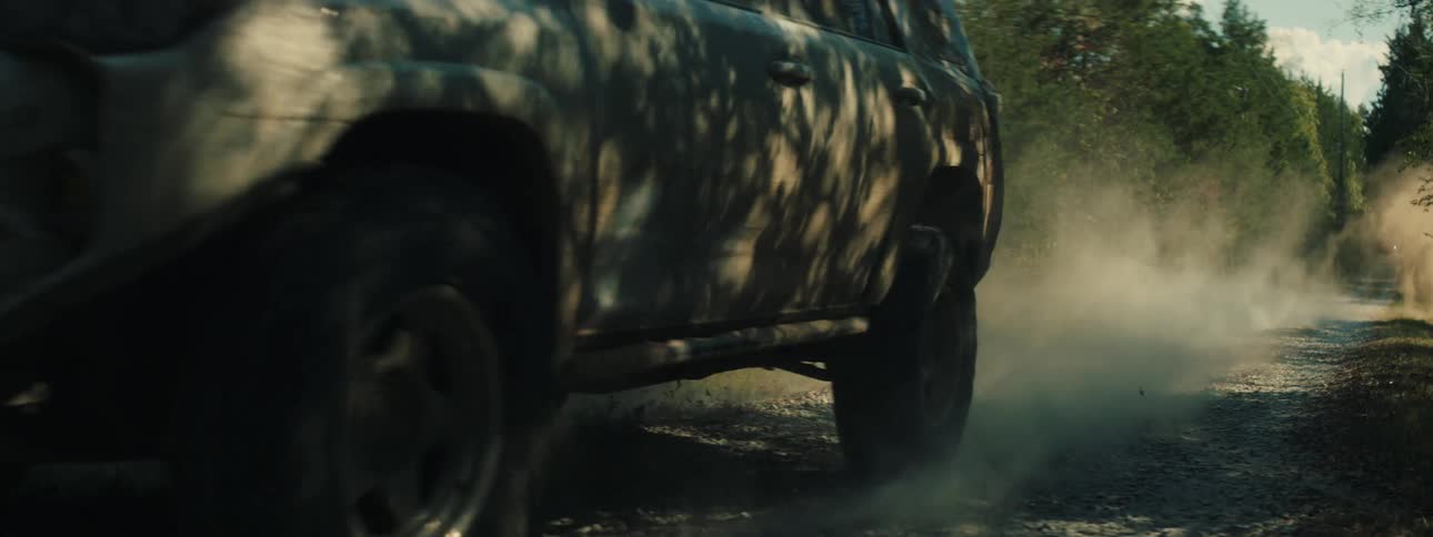 Pickup truck entering a curve quickly on a trail