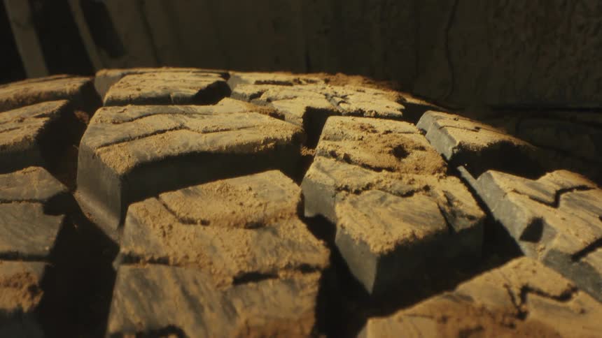 Offroad tire tread covered in dirt