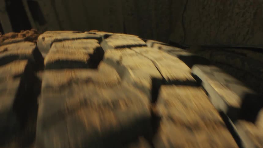 Offroad tire in motion covered in mud