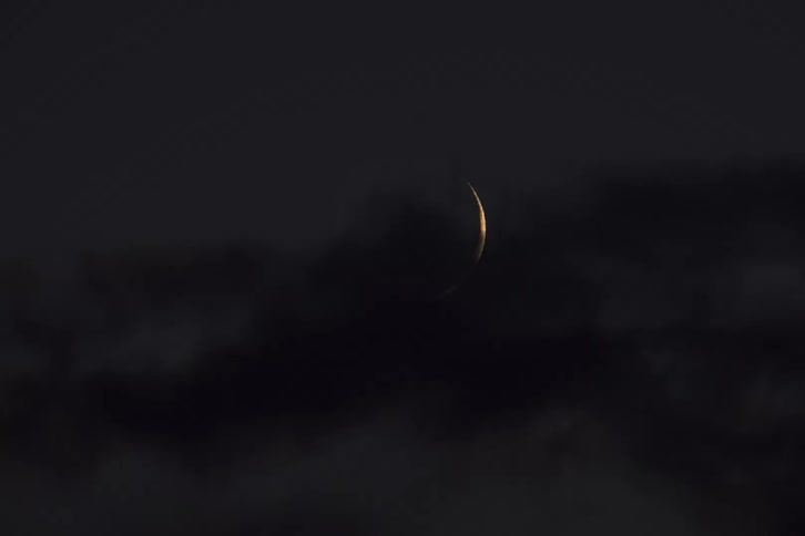 The crescent moon quickly sets