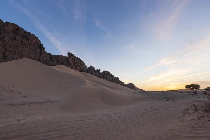 A time lapse of a desert landscape as the sun sets in the sky