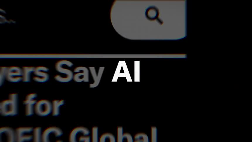 Various news headlines scrolling on a dark screen with the letters ai appearing in bold white font