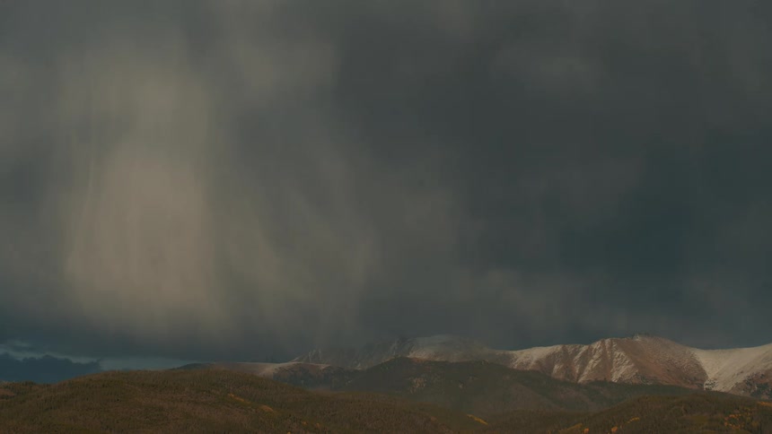 A view of some mountains with snow on them