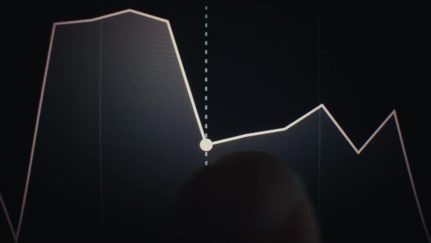 Finger points to a highlighted point on a line chart showing value variation