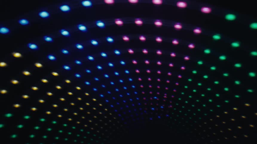 Colored luminous dots form a circular pattern on a dark background
