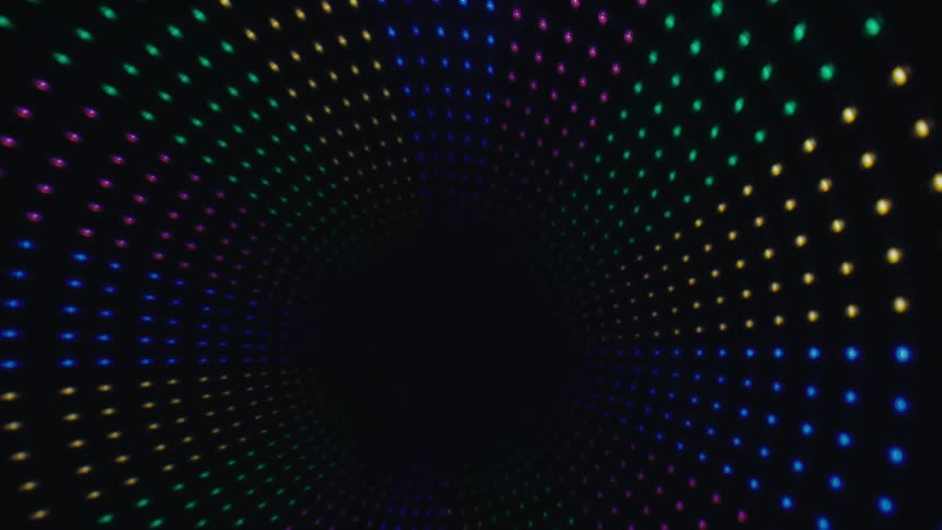A tunnel of vibrant led lights spiraling into a dark central abyss the colorful dots transition through a rainbow spectrum as the camera moves deeper into the vortex