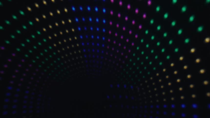 A view of colorful lights marking an arch at night