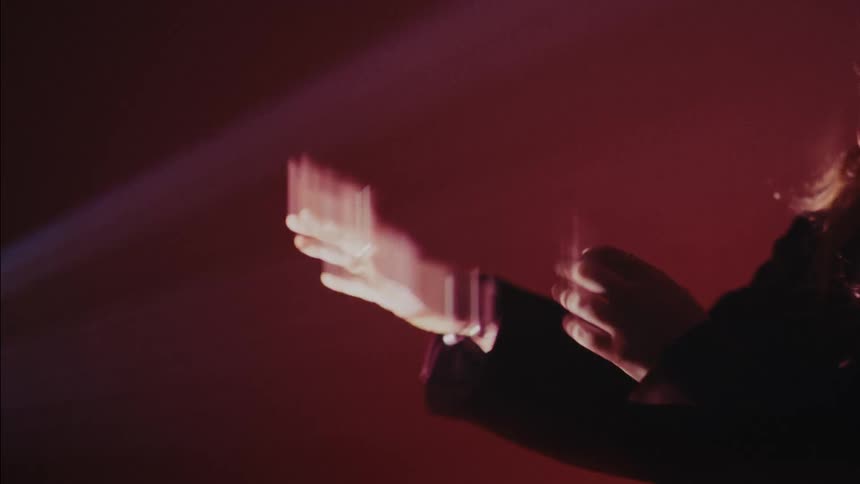 The woman is waving her hands in front of her