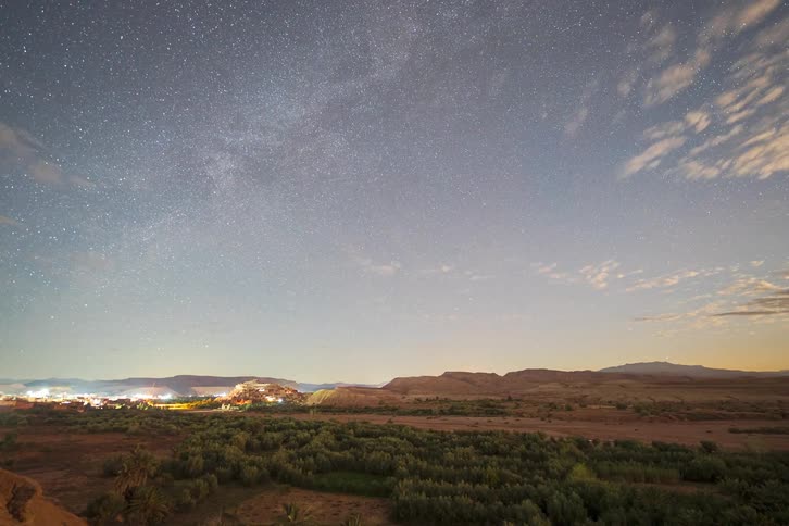 A time lapse of the sun setting over a desert landscape