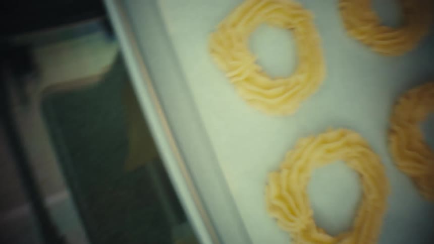 A person putting some food into an oven