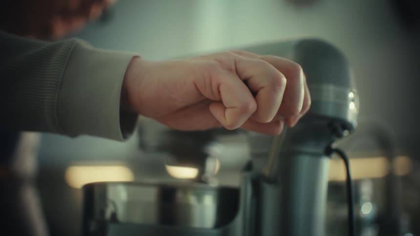 The man turns on the mixing machine