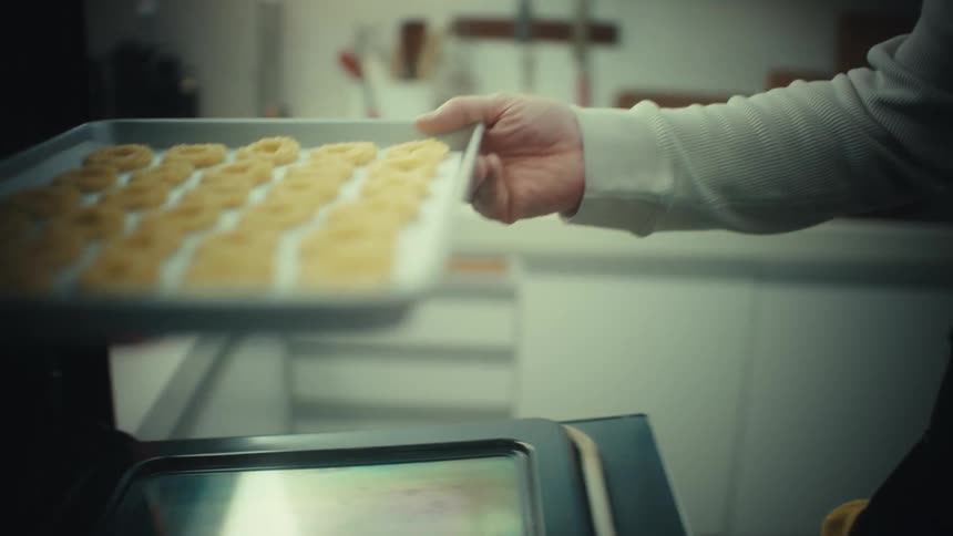 Tray with dough rings is placed inside the oven