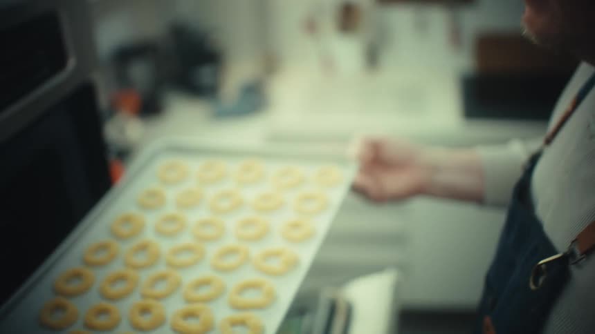 A man putting food into an oven