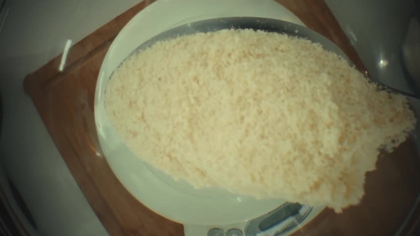 Spoon a portion of granulated sugar into the bowl