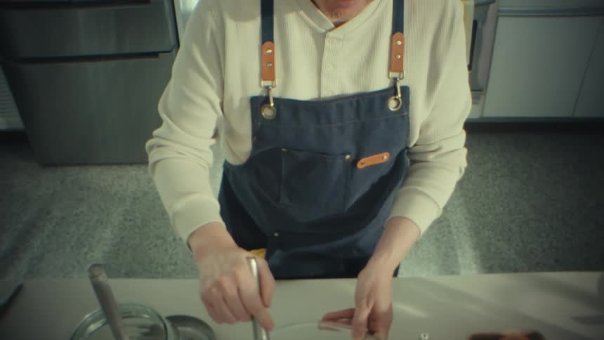 The man is mixing cream in the bowl