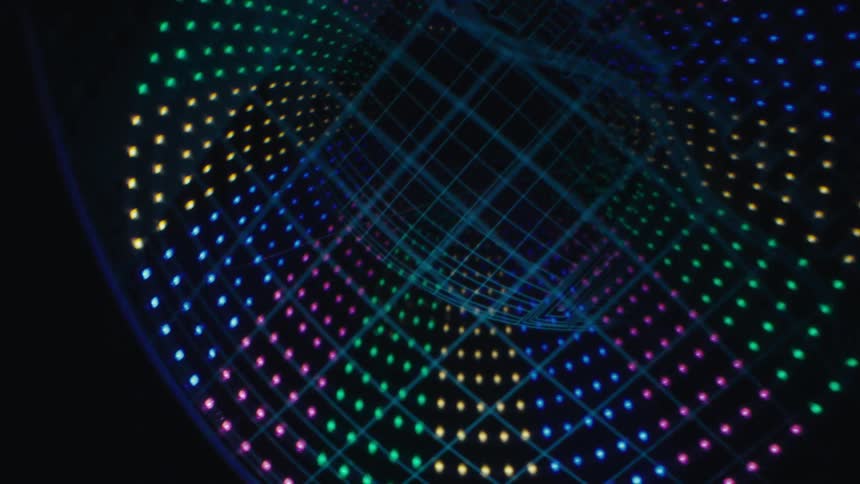 An animation of a glowing rainbow sphere with an american football floating in the middle against a dark background
