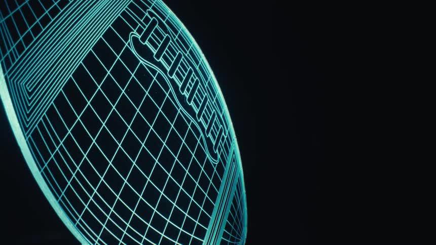 An animation of an american football drawn with blue lines on a dark background