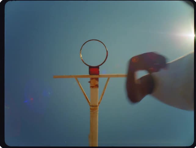 A man playing basketball outdoors