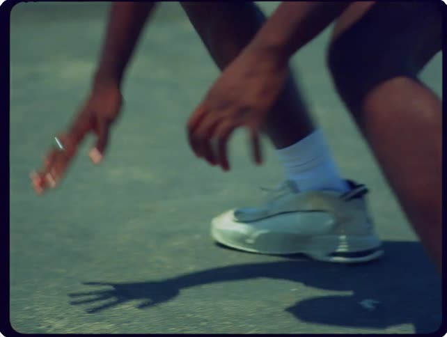 Man touches the ground on an outdoor court