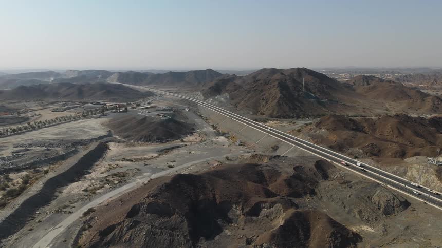 Automobiles traveling on a rural freeway through the mountains