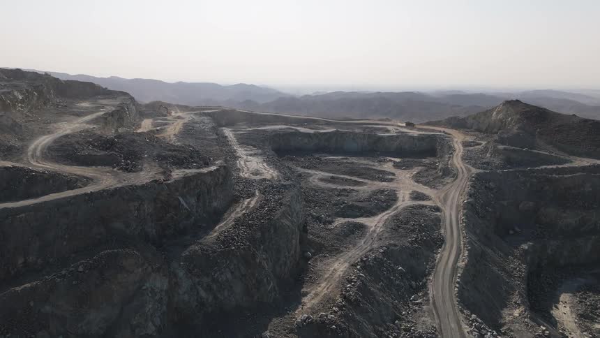 An aerial view of a mountain that has been carved and mined