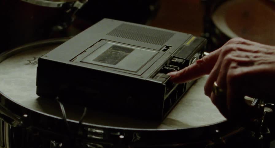 Pressing play on a cassette player on a drum
