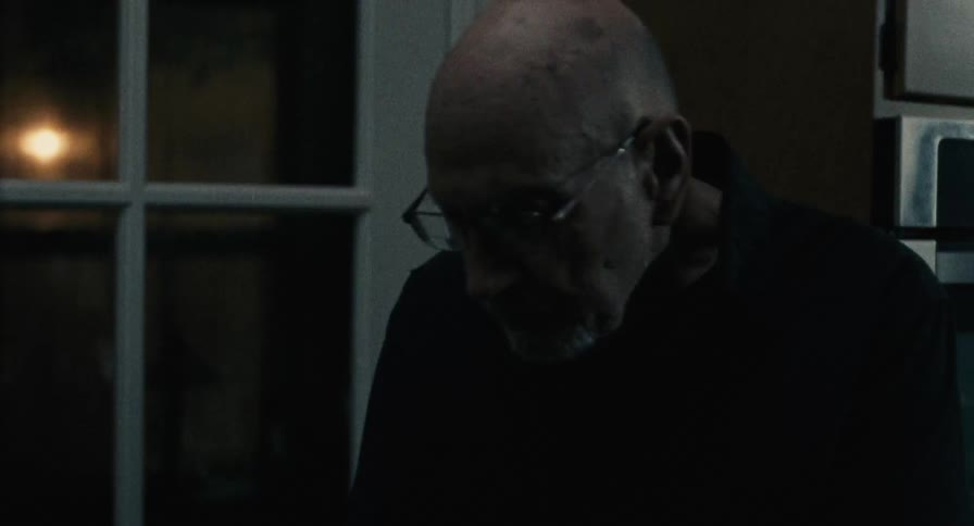Old man enters his house at night and takes off his coat