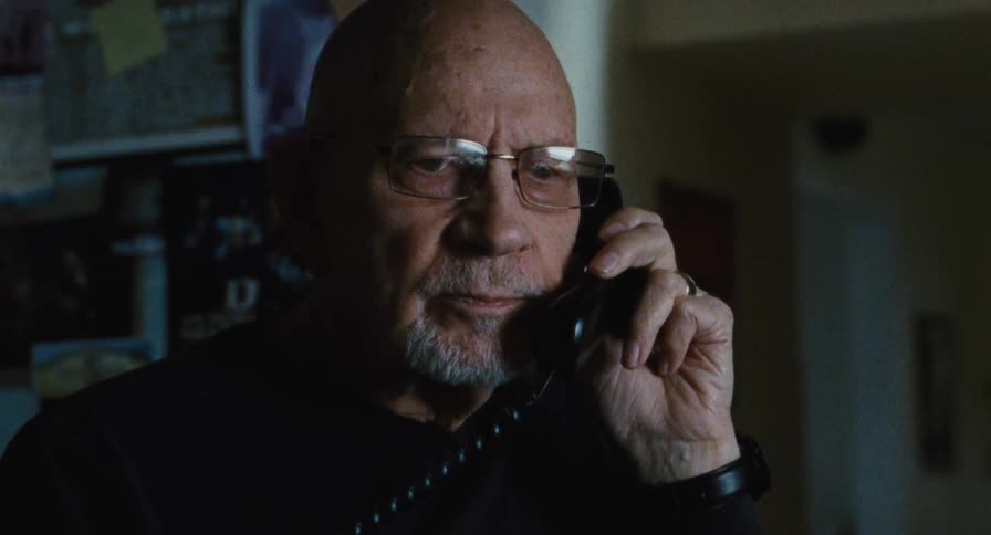 A man talking on a home phone
