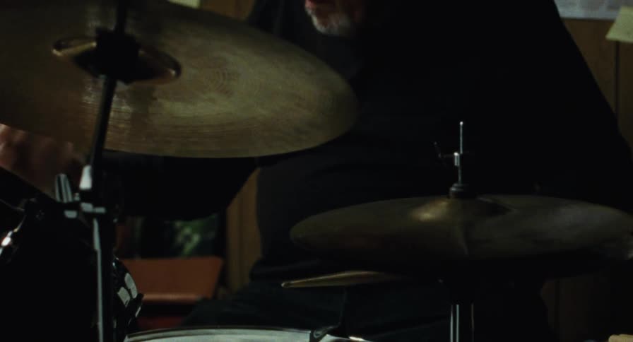 Old man plays the drums