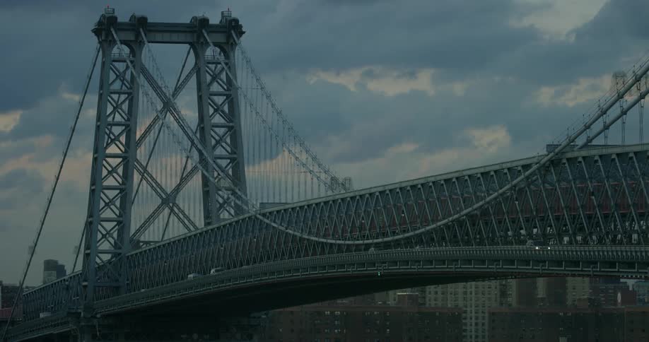 Cars drive across a city bridge