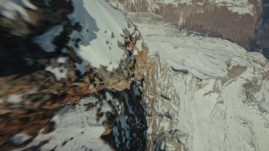 An aerial view of a mountain covered in snow