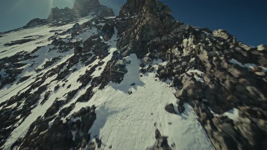 An aerial view flying over a mountain