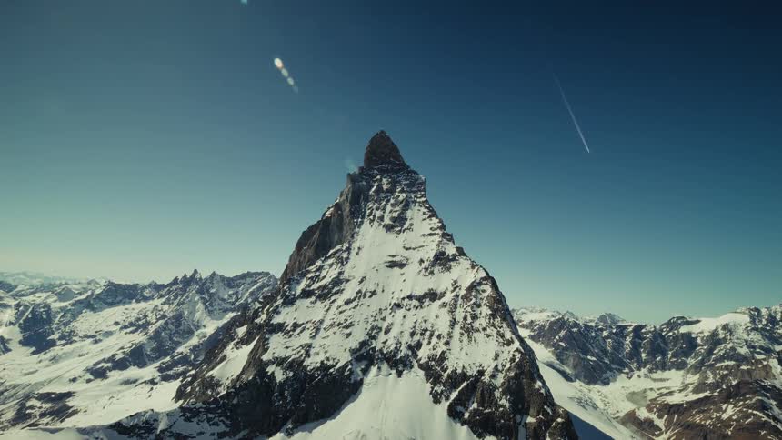 Swiss Matterhorn rising above a mountain range under a blue sky