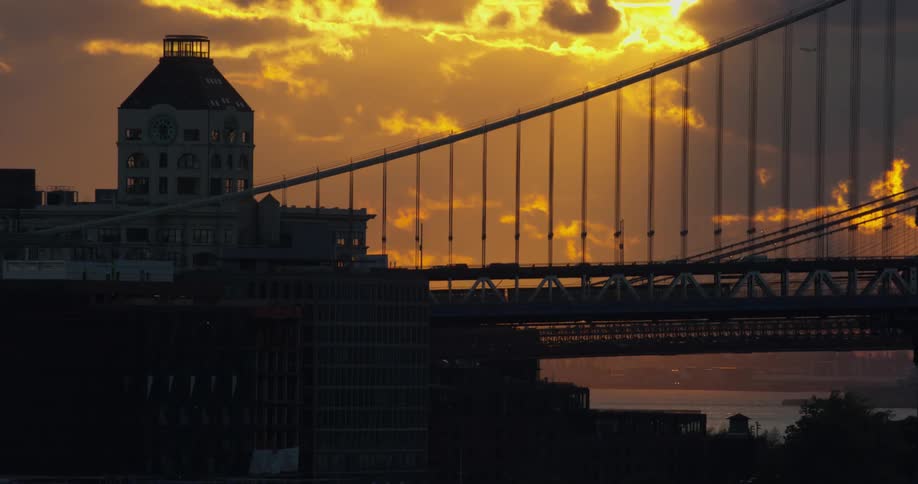Vehicles traveling on a bridge at sunset