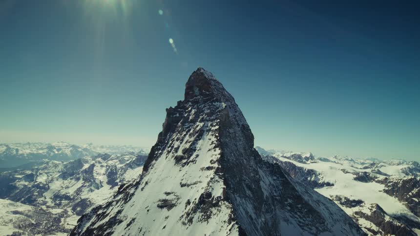 The iconic Swiss Matterhorn covered in snow on a sunny winter day aerial