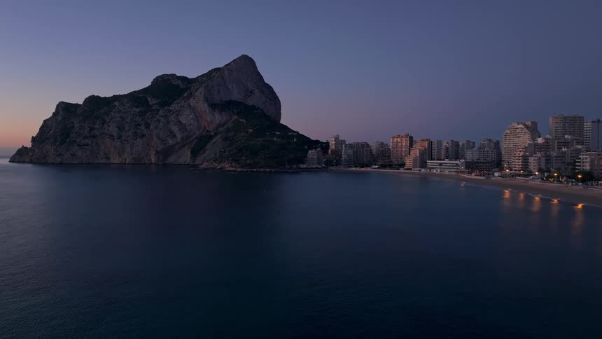 An aerial view of a city at sunset along the water