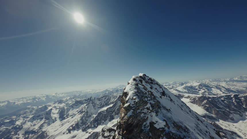 Snow-Covered Peak of the Matterhorn with Distant Mountains under a Bright Sunny Sky